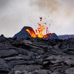 View of bonfire against mountain range