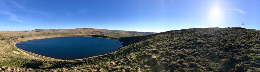 Panoramic view of landscape against blue sky