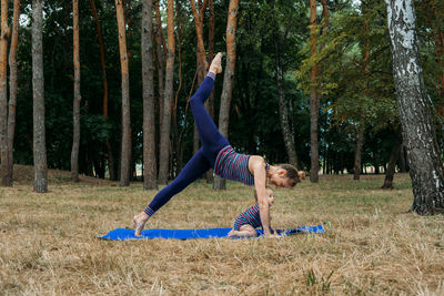 Mom and baby yoga outdoor. wellness, family yoga class, practicing mindfulness and meditation, 