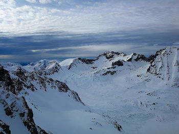 Scenic view of snow covered mountains against sky