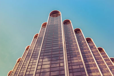 Low angle view of modern building against clear blue sky