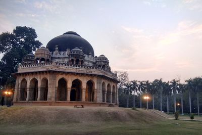 Old historical mosque against cloudy sky