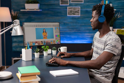 Side view of man using digital tablet in office