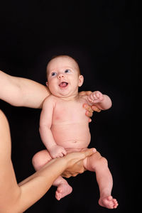 Portrait of cute baby against black background