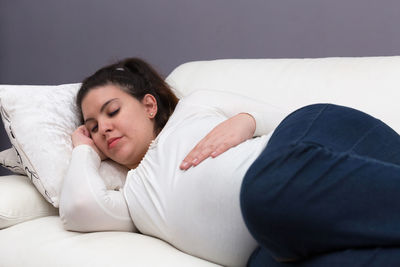 Woman sleeping on bed at home