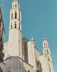 Low angle view of historic building against clear blue sky