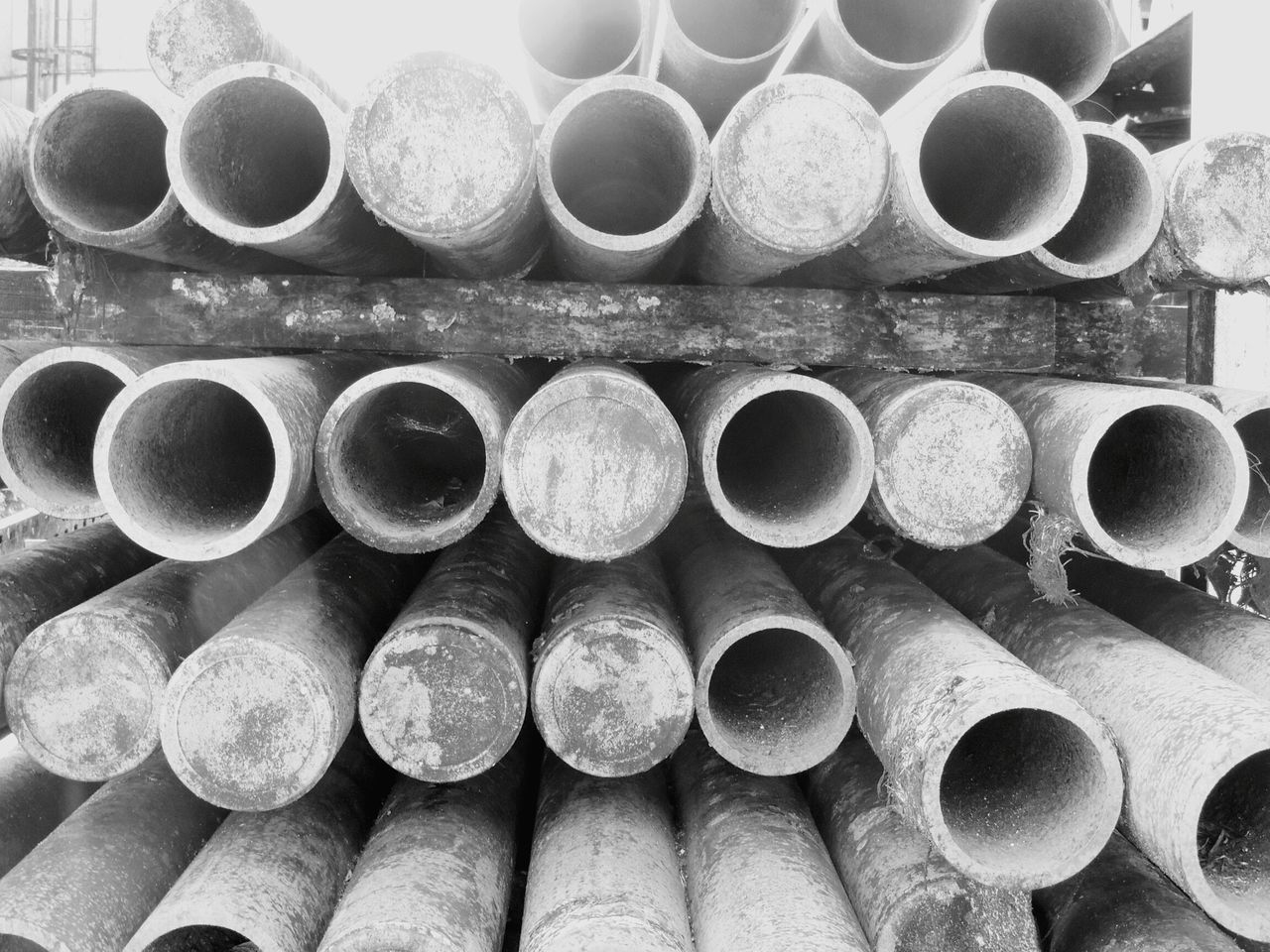 large group of objects, abundance, full frame, in a row, backgrounds, arrangement, order, stack, repetition, metal, indoors, side by side, metallic, close-up, industry, variation, still life, wood - material, circle, no people