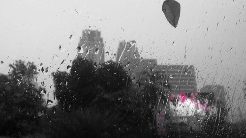 Raindrops on glass window in rainy season