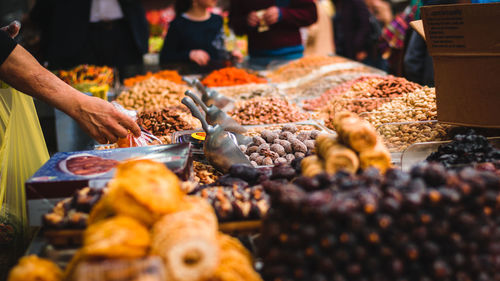 Cropped hand buying food at market