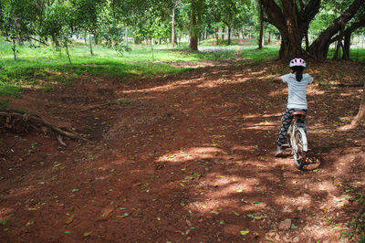 Girl riding bicycle on field