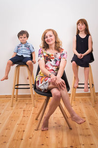 Portrait of smiling young woman sitting on chair