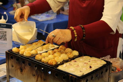 Midsection of man preparing food