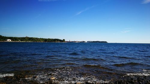 Scenic view of sea against clear blue sky