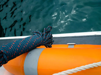 Close-up of inflatable float and rope over sea