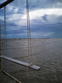 Sailboat on sea shore against sky