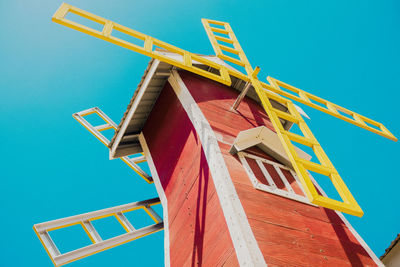 Low angle view of information sign against blue sky