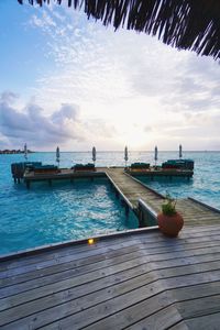 Scenic view of pier at sea against sky