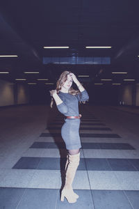 Portrait of young woman standing in subway