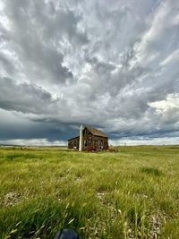 Built structure on field against sky