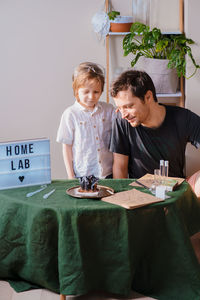 Father and son experimenting in the home laboratory and studying the chemical properties