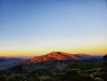 Scenic view of mountains against clear sky during sunset