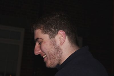 Side view of smiling man in darkroom