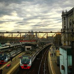 Railroad tracks against cloudy sky