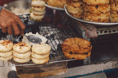 Cropped hand of man preparing food for sale