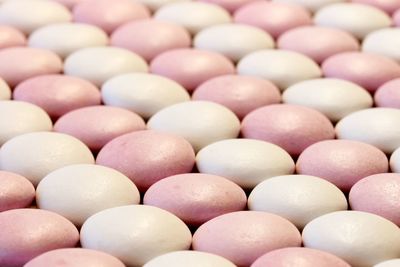 Full frame shot of pink and white macaroons