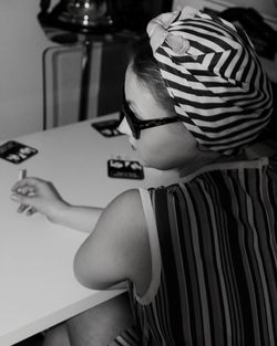 High angle view of woman sitting on table at home