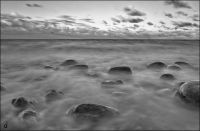 Scenic view of sea against cloudy sky