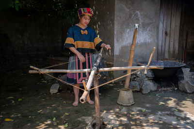 Portrait of boy sitting on wood