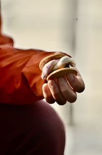 Cropped hand of woman holding nail polish
