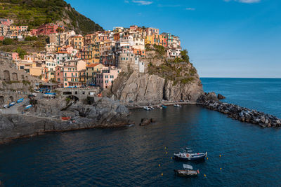 Scenic view of sea by buildings against sky