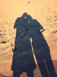 Shadow of people on beach