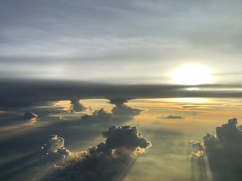 Sunlight streaming through clouds during sunset