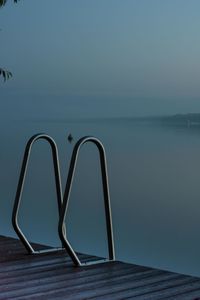 Swimming pool against sea against clear sky