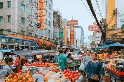 People at market stall in city