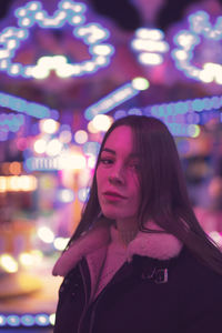 Portrait of beautiful woman standing at night