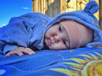 Portrait of cute baby lying on bed