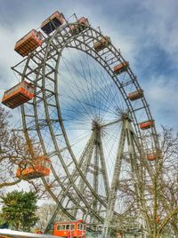 Low angle view of ferris wheel against sky