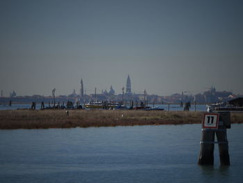 Panoramic view of river and buildings against clear sky