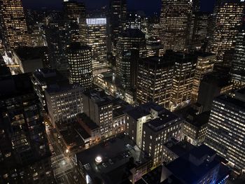 High angle view of illuminated modern buildings in city at night