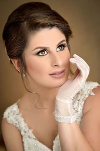 Close-up of bride with hand on chin looking away