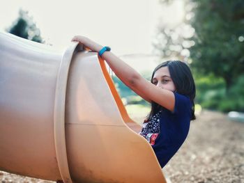 Young woman standing in car