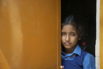 Portrait of girl standing at entrance