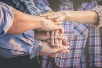 Friends stacking hands