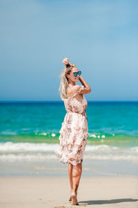 Full length of woman standing on beach