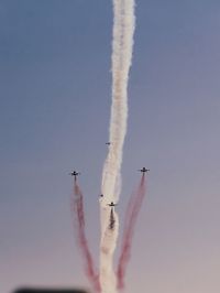 Low angle view of airshow against sky