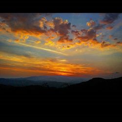 Scenic view of mountains against dramatic sky